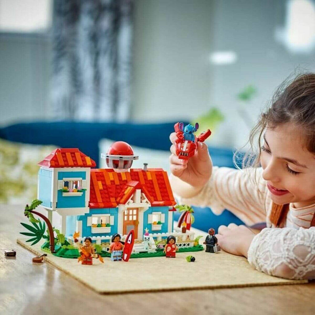 Child playing with Construction set Lego Disney Lilo & Stitch 43268 834 Pieces in a colorful setting.