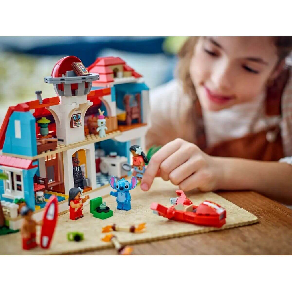 Child playing with Construction set Lego Disney Lilo & Stitch 43268 834 Pieces, featuring colorful characters and accessories.