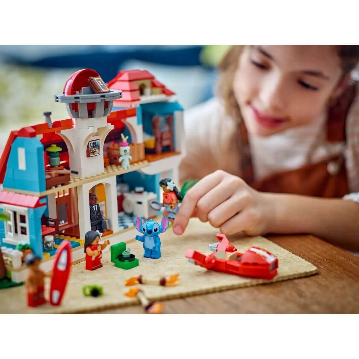 Child playing with Construction set Lego Disney Lilo & Stitch 43268 834 Pieces, featuring colorful characters and accessories.