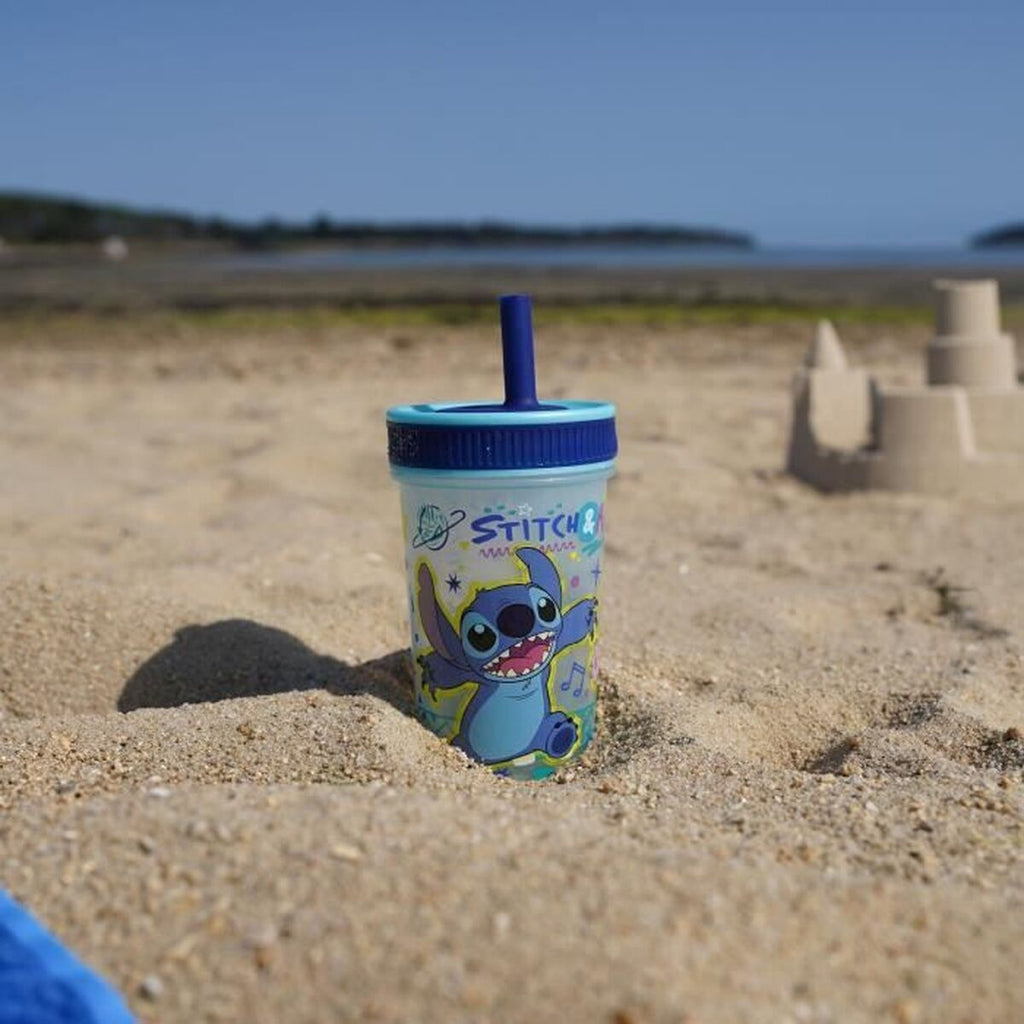 Training Glass ThermoBaby LILO & STITCH 420 ml Blue on sandy beach with playful design.