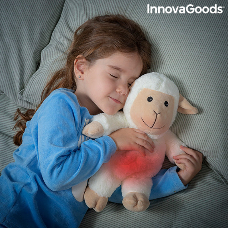 Sheep Soft Toy with Warming and Cooling Effect Wooly InnovaGoods being cuddled by a child in bed.