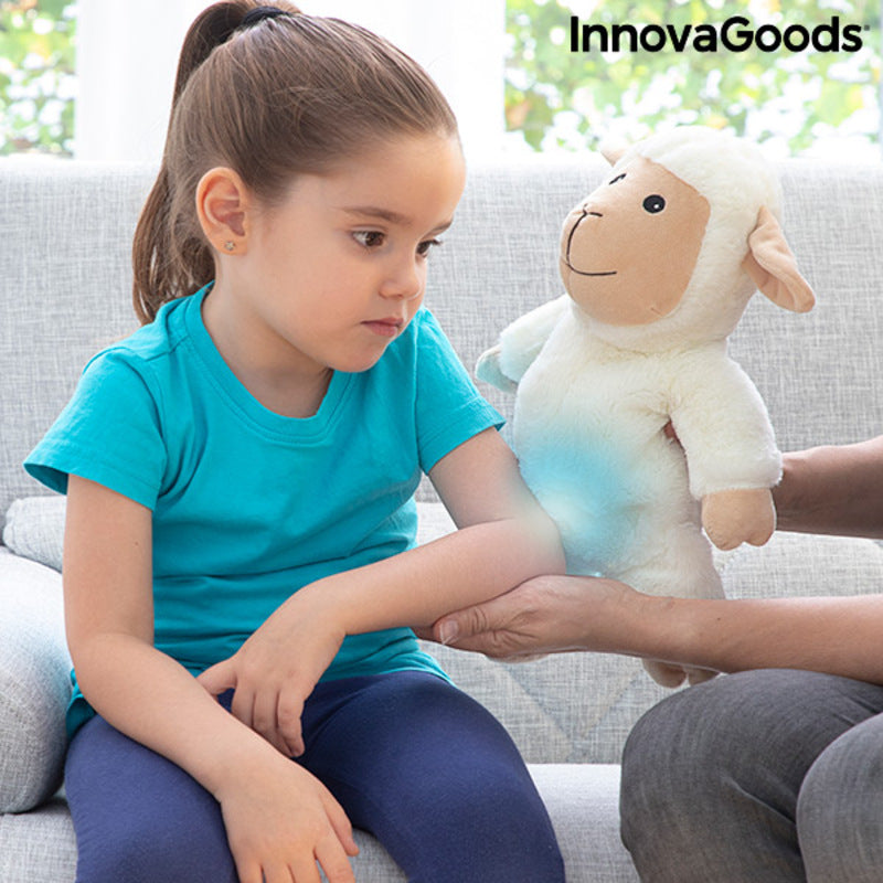 Sheep Soft Toy with Warming and Cooling Effect Wooly InnovaGoods used by a child for comfort on a sofa.