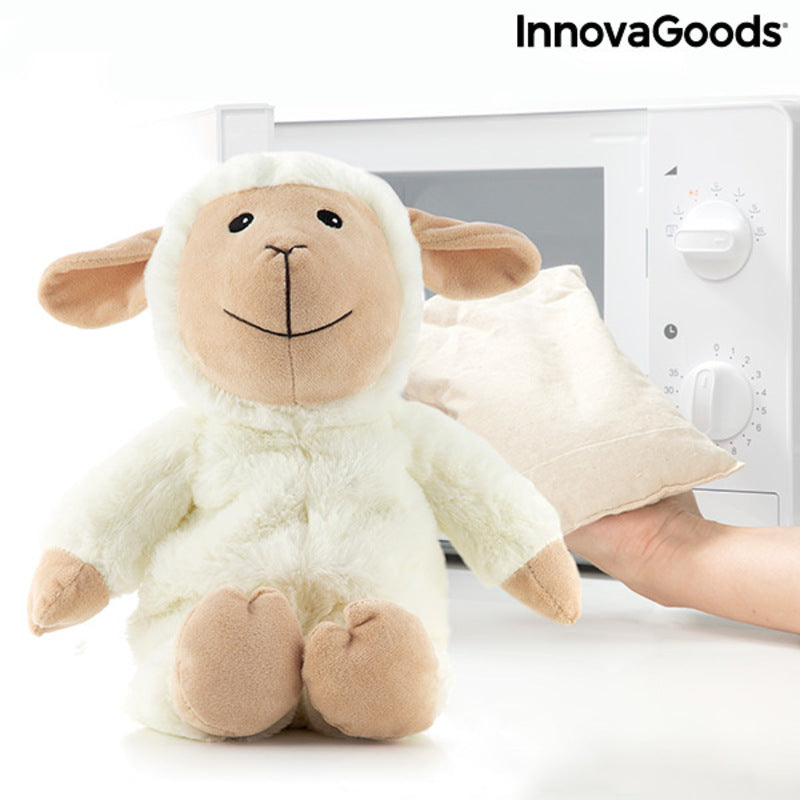 Sheep Soft Toy with Warming and Cooling Effect Wooly InnovaGoods beside a microwave with a heat pack.