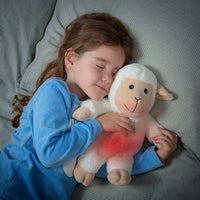 A girl sleeping peacefully with a Sheep Soft Toy with Warming and Cooling Effect Wooly InnovaGoods in her arms.