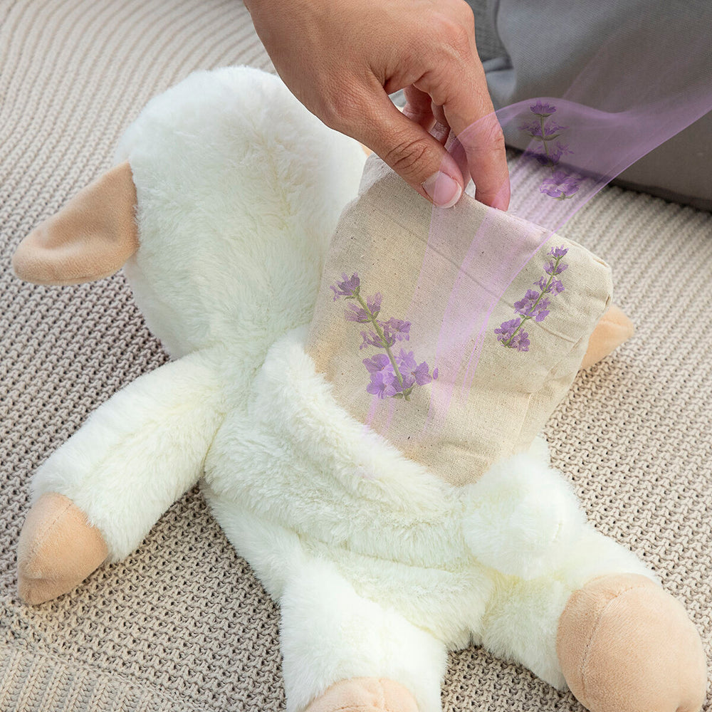 Sheep Soft Toy with Warming and Cooling Effect Wooly InnovaGoods being used with lavender sachet for soothing comfort.