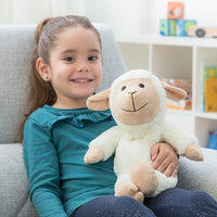 Sheep Soft Toy with Warming and Cooling Effect Wooly InnovaGoods held by a smiling girl in a cozy setting.
